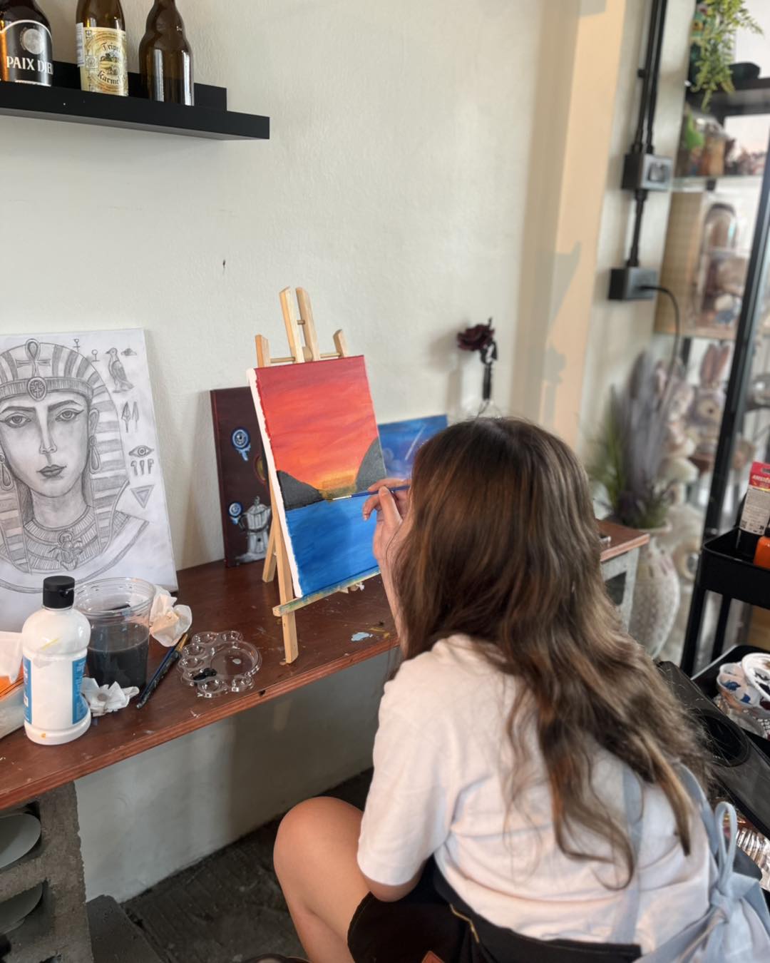 A guest painting a colourful sunset
